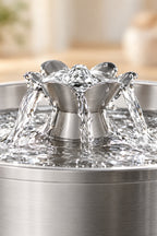 Water flowing over the flower spout of the fountain
