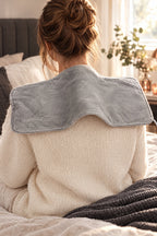 The heat pad draped over the shoulders