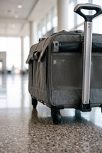 Voyage rolling carrier handle and wheel close-up